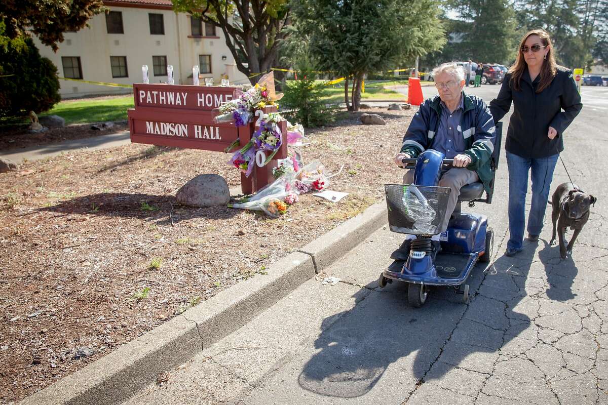 Veteran Home of California resident, Ernest Powell, who served in Korea, with his daughter Tracy, strolls passed a make shift memorial after laying flowers for the three Pathway Home employees that were killed by a former patient on Friday March 09 in Yountville, California, USA 11 Mar 2018.