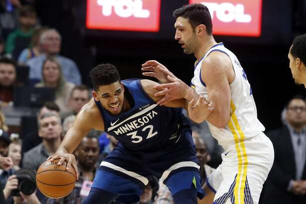 Minnesota Timberwolves' Karl-Anthony Towns, left, works his way around Golden State Warriors' Zaza Pachulia in the second half of an NBA basketball game Sunday, March 11, 2018, in Minneapolis. (AP Photo/Jim Mone)