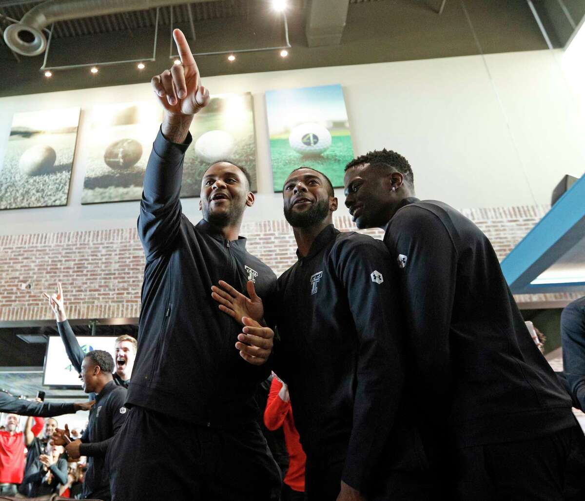 Texas Tech's Tommy Hamilton, Niem Stevenson and Norense Odiase celebrate after finding out where the Red Raiders will play during a watch party for the NCAA basketball tournament Sunday, March 11, 2018, in Lubbock, Texas. (Brad Tollefson/Lubbock Avalanche-Journal via AP)