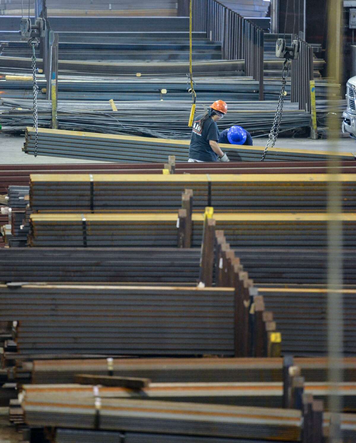 Workers move material at Alamo Iron Works. New tariffs on steel have brought higher prices for many manufacturers and construction firms and considerable uncertainty for both importers and domestic manufacturers of steel and aluminum.