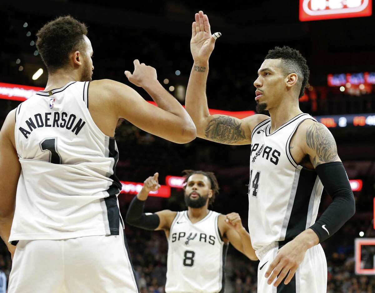 San Antonio Spurs forward Kyle Anderson (1) Patty Mills (8), and Danny Green (14) celebrate after the game against the Memphis Grizzlies Monday March 5, 2018 at the AT&T Center.
