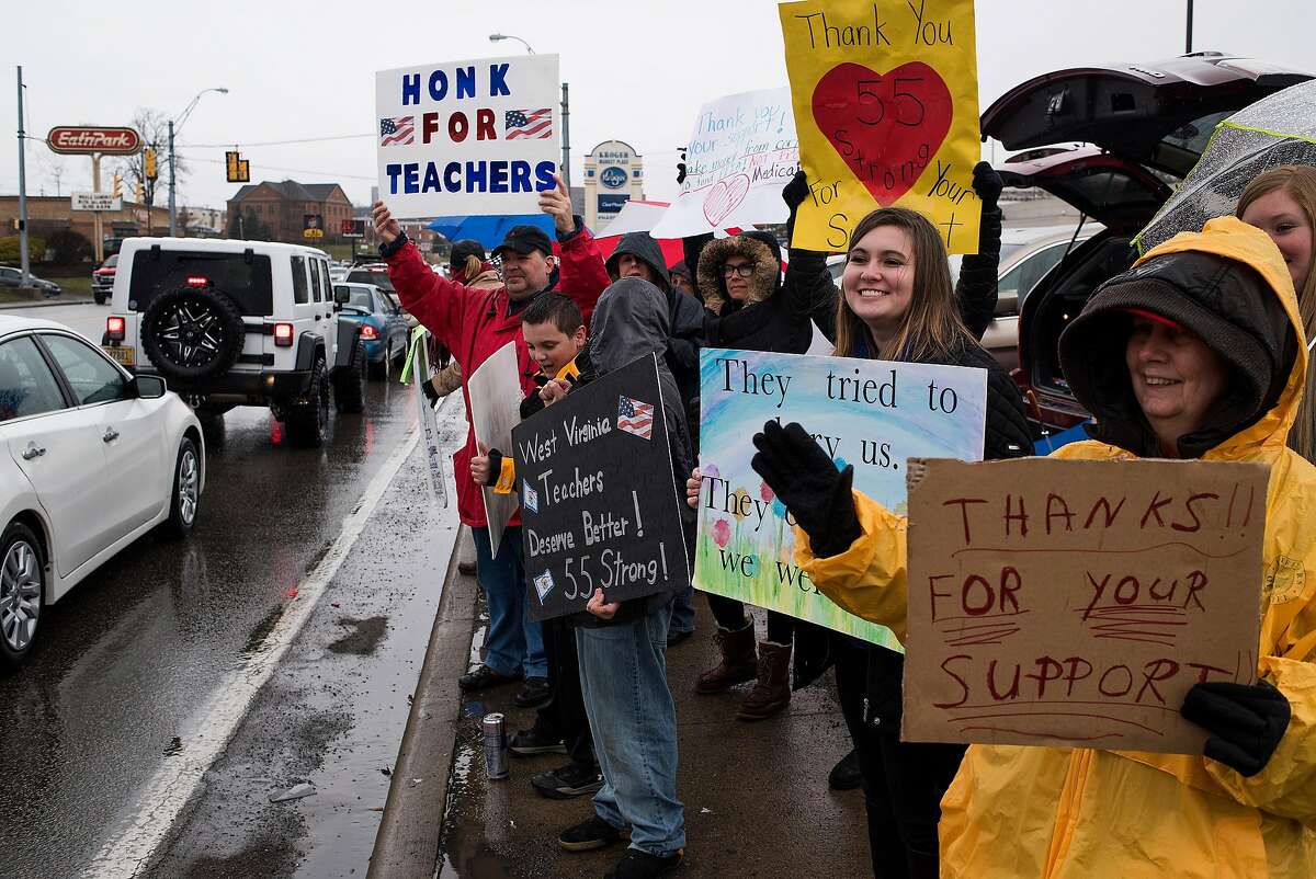 Educators and students hold up signs in support of a statewide teachers� strike in Morgantown, W.Va., March 6, 2018. With their victory after a nine-day walkout, West Virginia teachers demonstrated a new model for collective labor action beyond the traditional parameters of unions. (Ty Wright/The New York Times)