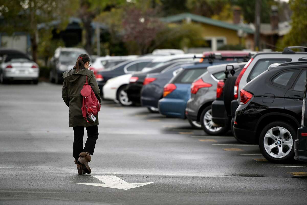 A person walks through the parking lot at the North Berkeley BART station in Berkeley, CA, on Friday March 2, 2018.