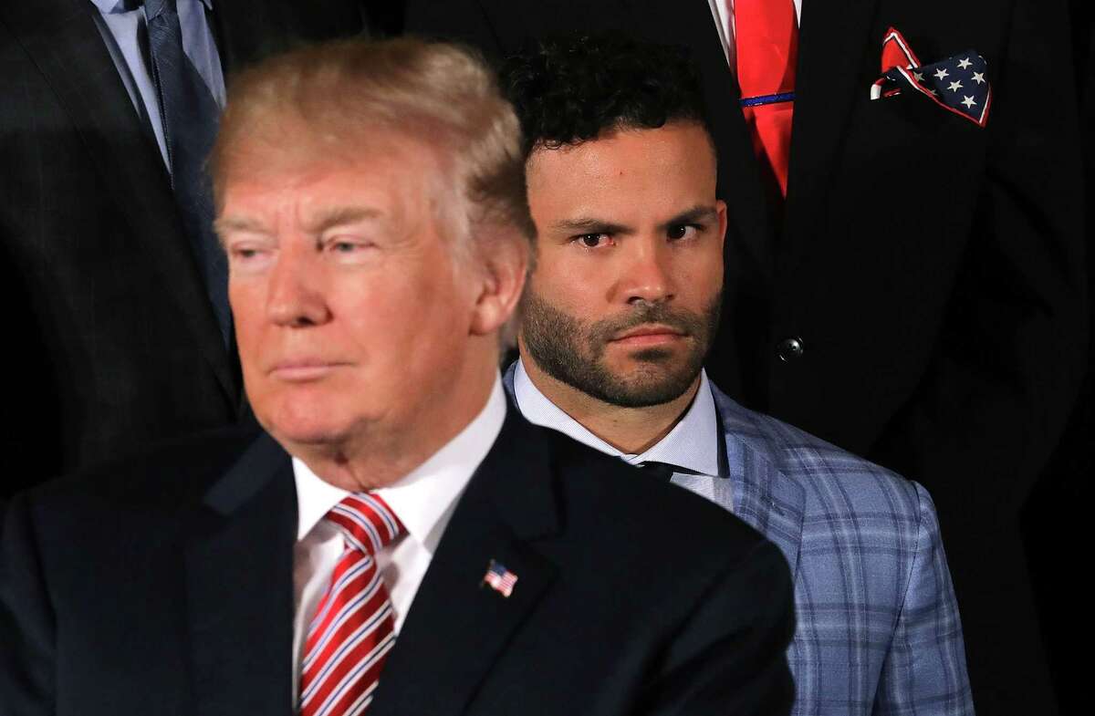 WASHINGTON, DC - MARCH 12: Houston Astros second baseman Jose Altuve (R) watches U.S. President Donald Trump during a celebration of the team's World Series victory in the East Room of the White House March 12, 2018 in Washington, DC. Trump talked about Hurricane Harvey and the city and team's resilience in the face of the storm.