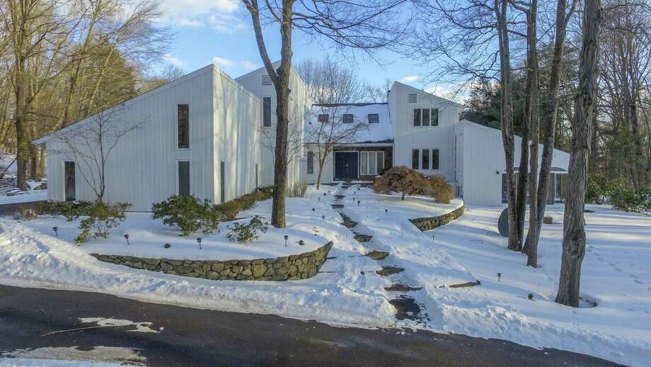 The contemporary house at 1 Winslow Road in Weston is like a spa/resort with an indoor swimming pool, sauna, exercise room, aerated pond, and immediate access to managed hiking trails and protected open space. Photo: Contributed Photos