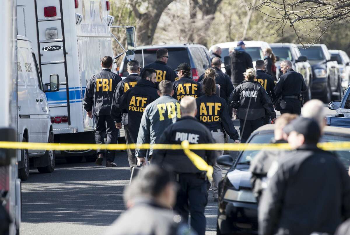 Authorities investigate the scene in East Austin after a teenager was killed and a woman was injured in the second Austin package explosion in the past two weeks on Monday, March 12, 2018. (Ricardo B. Brazziell/Austin American-Statesman/TNS)