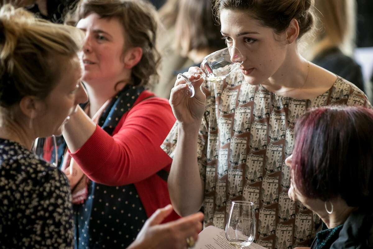 The third Brumaire, above, sold out this year and featured 51 wineries, about double the number from 2016. The event, which features natural wines from around the world, was held at the Starline Social Club in Oakland. Here, vintner Athénaïs Béru pours her wine for Virginia Samsel, left, and Claire Hill.