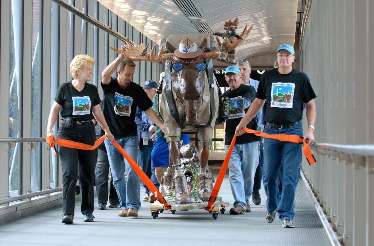 "On The Trail Again," a seven-foot-tall fiberglass moose created by artists Bill Brassard and Paul Hilliard, is wheeled into Albany international Airport Monday morning Sept. 28, 2009. The moose is on display at the airport to promote the Bennington 2009 Moosefest, which runs through the fall. (Will Waldron / Times Union)