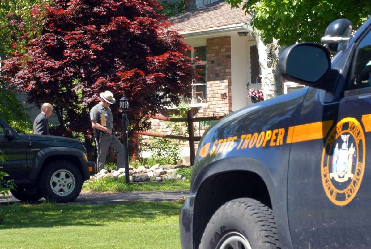 State Police investigate the scene at the home of Gary Veeder, a longtime forensic scientist for the New York State Police, who committed suicide at his home in Voorheesville in 2008. (WILL WALDRON / TIMES UNION )