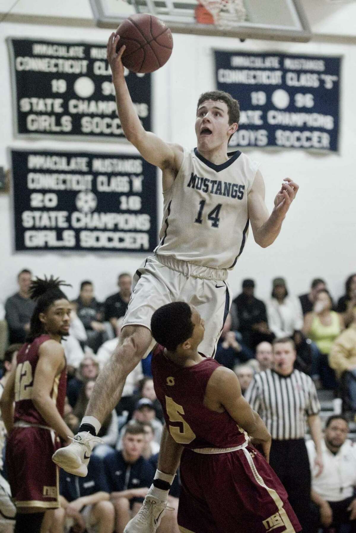 Immaculate High School's Ronan Doherty goes up to the basket in the Division II boys basketball quarterfinals against New Britain High School, played at Immaculate. Monday, March 12, 2018