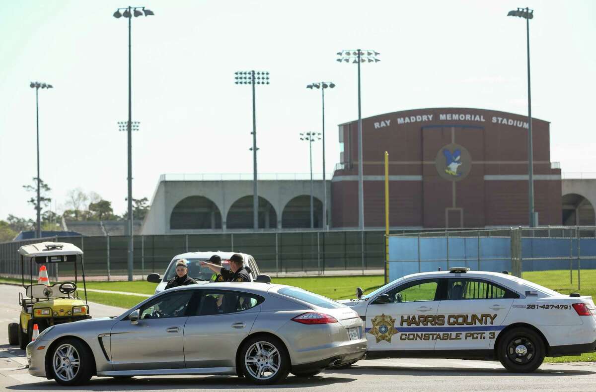 Harris County Precinct 3 Constable’s Office deputies guide traffic into Channelview High School on the intersection of Crockett and Sheldon roads Tuesday, March 13, 2018, in Channelview, Texas. Students in the marching band were injured after their charter bus, traveling back from a trip to Disney World, drive off the Interstate 10 near Mobile, Alabama.