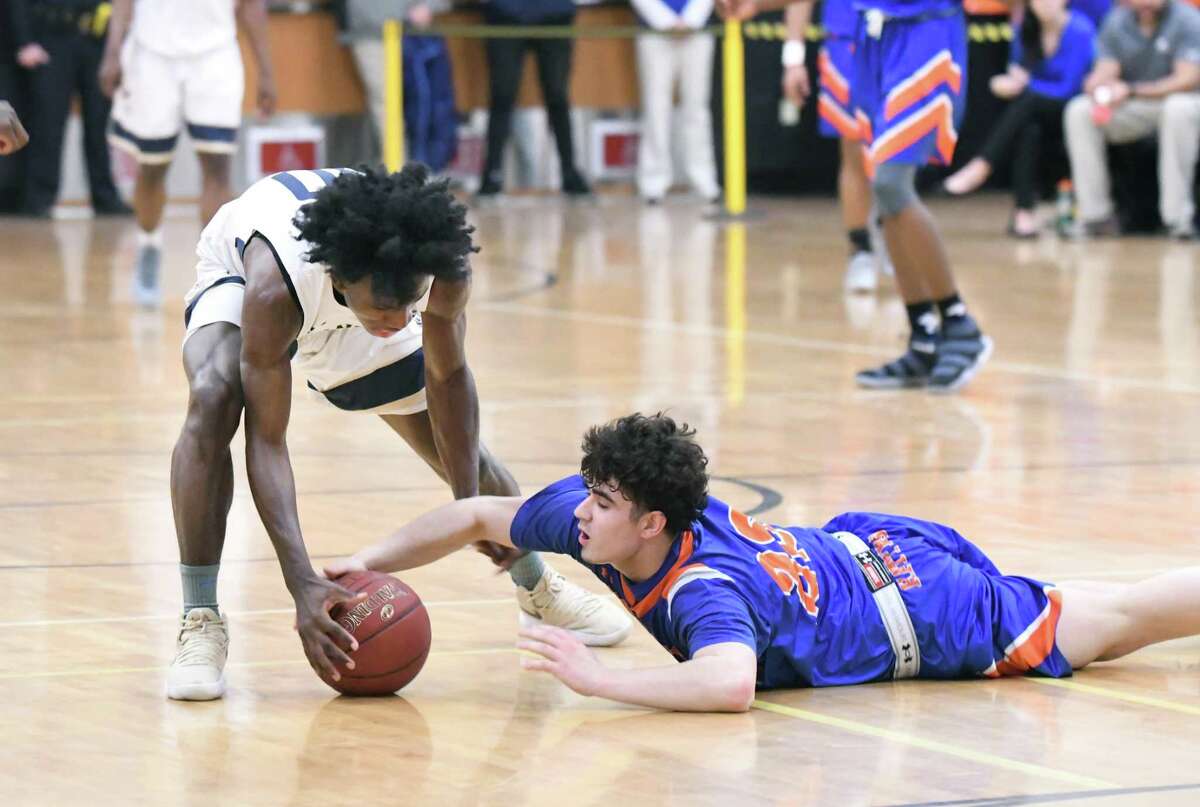 Notre Dame?’s Woodley Monnexant, left, and Danbury?’s Cameron Snow scramble for a loose ball during the Division I boys basketball quarterfinals between Danbury and Notre Dame-Fairfield at Trumbull High, March 12, 2018.