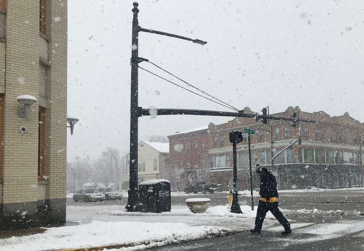 Main Street was mostly unpopulated Tuesday afternoon in Middletown. Here, a man crosses the street at Grand and Main at the height of the heaviest snowfall.