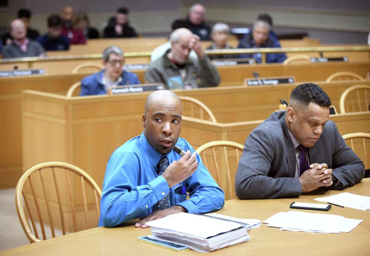 New Haven Acting Budget Director Michael Gormany (center) speaks before the New Haven Board of Alderman Finance Committee at City Hall in New Haven March 12, 2018. At right is Controller Daryl Jones.