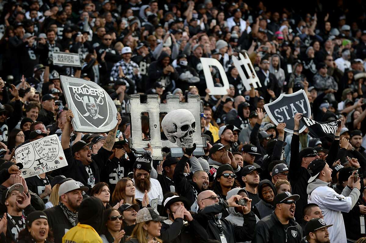 Oakland Raiders fans in The Black Hole celebrate the team's play against the Carolina Panthers on November 27, 2016, at the Coliseum in Oakland, Calif. (Jeff Siner/Charlotte Observer/TNS)