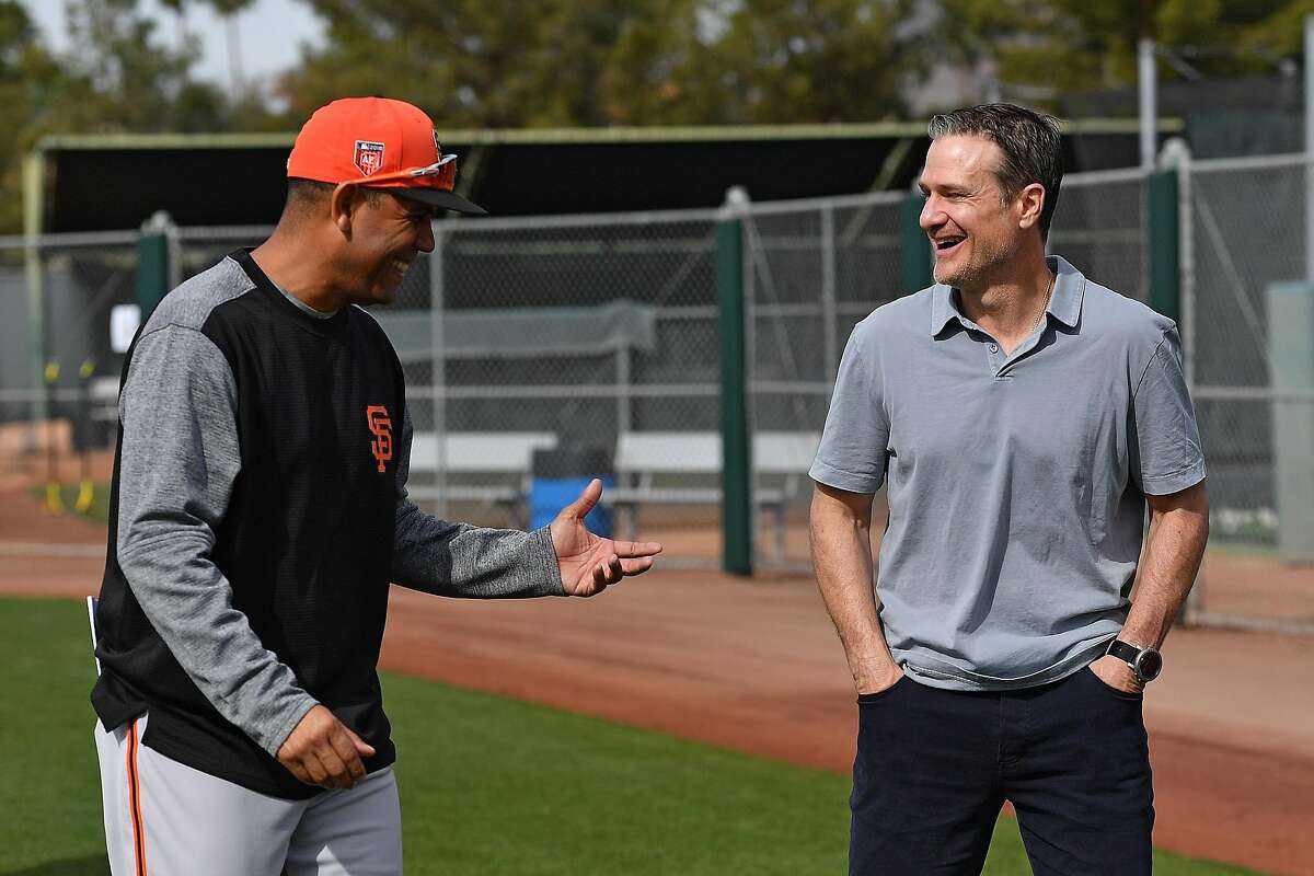 Scottsdale, AZ - March 8: David Bell of the San Francisco Giants laughs with manager of Dominican Summer League Giants Jose Montilla at the Giants minor-league complex on March 8, 2018 in Scottsdale, Arizona.