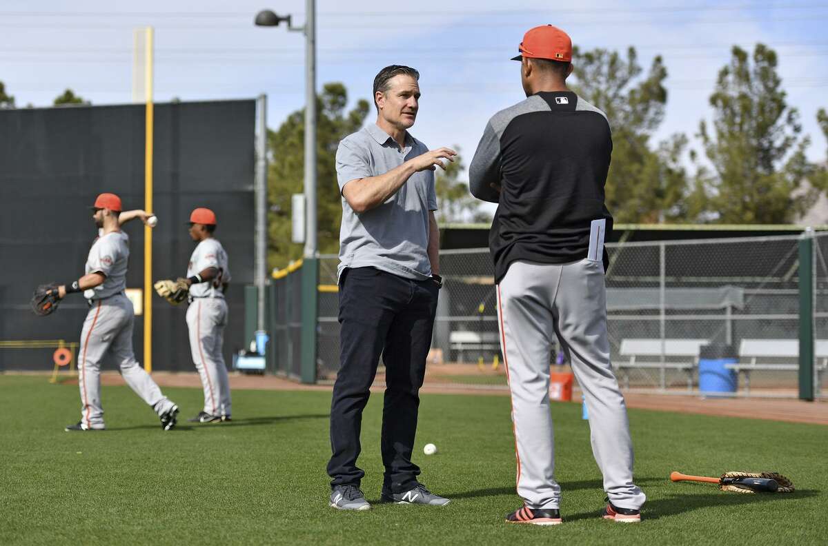 Scottsdale, AZ - March 8: David Bell of the San Francisco Giants talks with manager of Dominican Summer League Giants Jose Montilla at the Giants minor-league complex on March 8, 2018 in Scottsdale, Arizona.