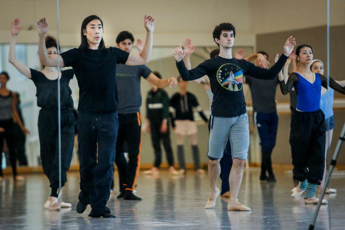 Choreographer Edwaard Liang, left front, directs his dancers during a rehearsal session for "Unbound."