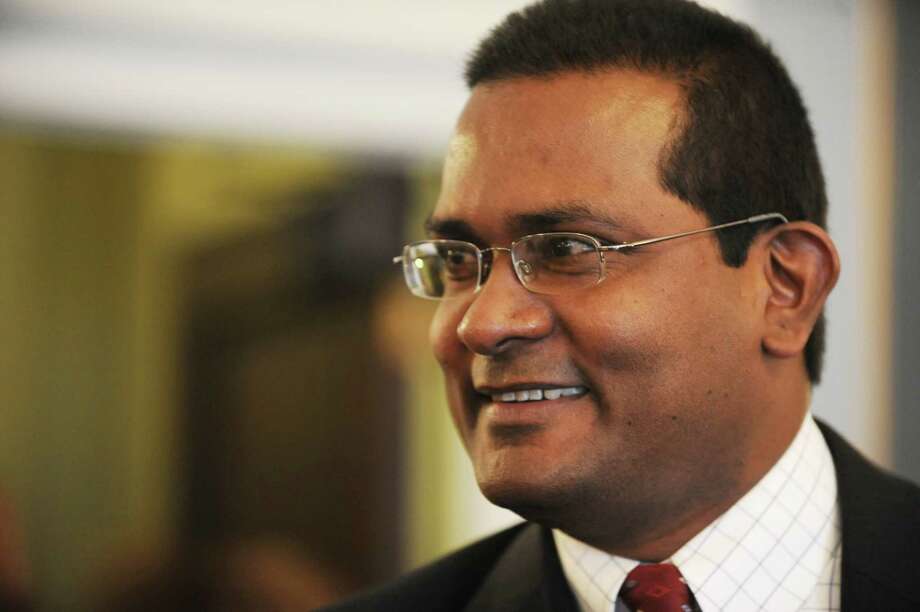 John Mootooveren smiles after taking oath for city council administered by Honorable Mark Blanchfield at Schenectady City Hall on Wednesday, Jan. 1, 2014 in Schenectady, N.Y.  Mootooveren is the city's first Guyanese city council member. (Lori Van Buren / Times Union) Photo: Lori Van Buren / 00025222A