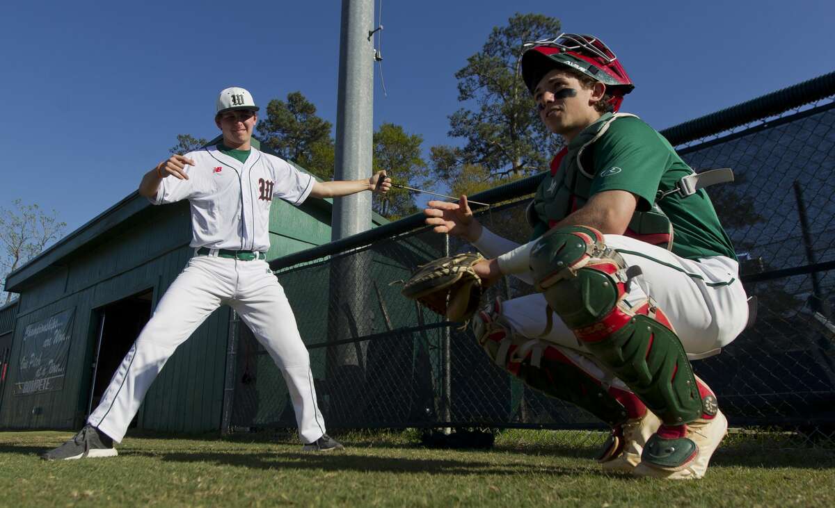 The Woodlands starting pitcher Steven Beard warms up beside catcher Drew Romo before a District 12-6A high school baseball game, Tuesday, March 13, 2018, in The Woodlands.