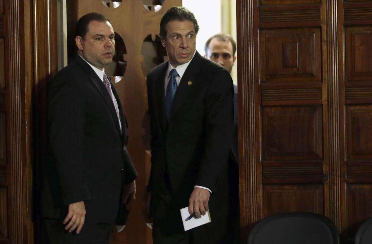 Joseph Percoco, executive deputy secretary, left, and Gov. Andrew Cuomo, right, enter the Red Room Friday, April 26, 2013, during a press conference at the Capitol in Albany, N.Y. (AP Photo/Mike Groll)