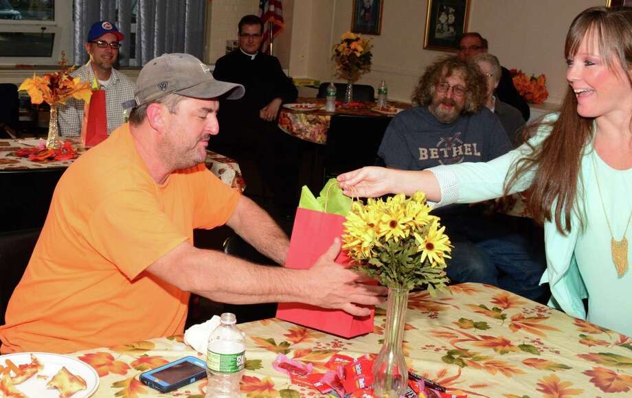 File photo of Megan Alworth-Khazadian, social worker for the town of Bethel, giving a goody bag with donations to Paul Gorman who was affected by the fire that happened over the summer on Greenwood Avenue. The event took place at the Senior Center in Bethel on Wednesday October 4, 2017. The Social Services Department is collecting items for Easter baskets for families in need. Photo: Lisa Weir / For Hearst Connecticut Media / The News-Times Freelance