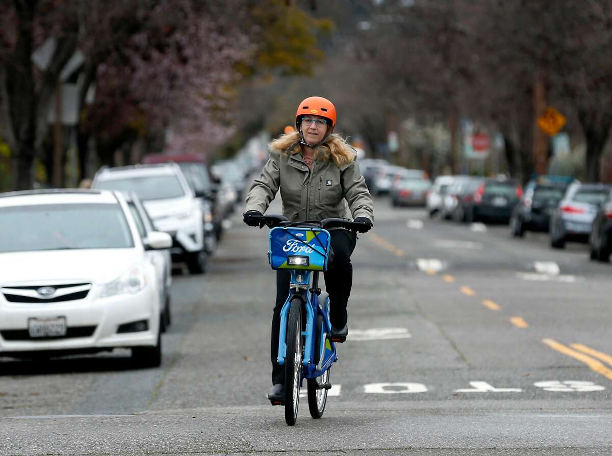 Wendy Wheeler starts her three-mile bicycle commute on a Ford GoBike in the Rockridge neighborhood in Oakland, Calif. on Thursday, March 8, 2018. A few weeks back, Wheeler narrowly avoided an accident after discovering a vandal had cut the brake line on one of the shared bikes she was riding.
