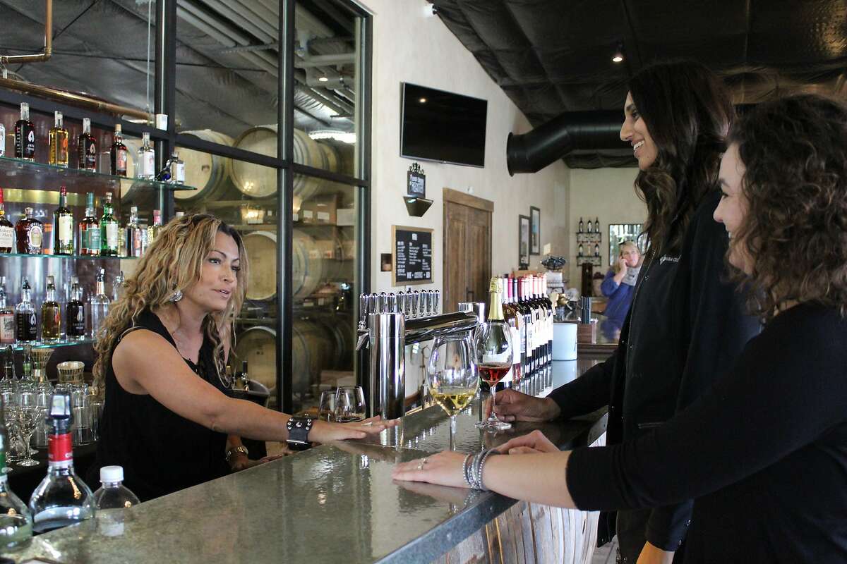 Carol Bertagna pours samples of Pinot Grigio and Syrah Rosé at her family’s Almendra Winery in Durham.
