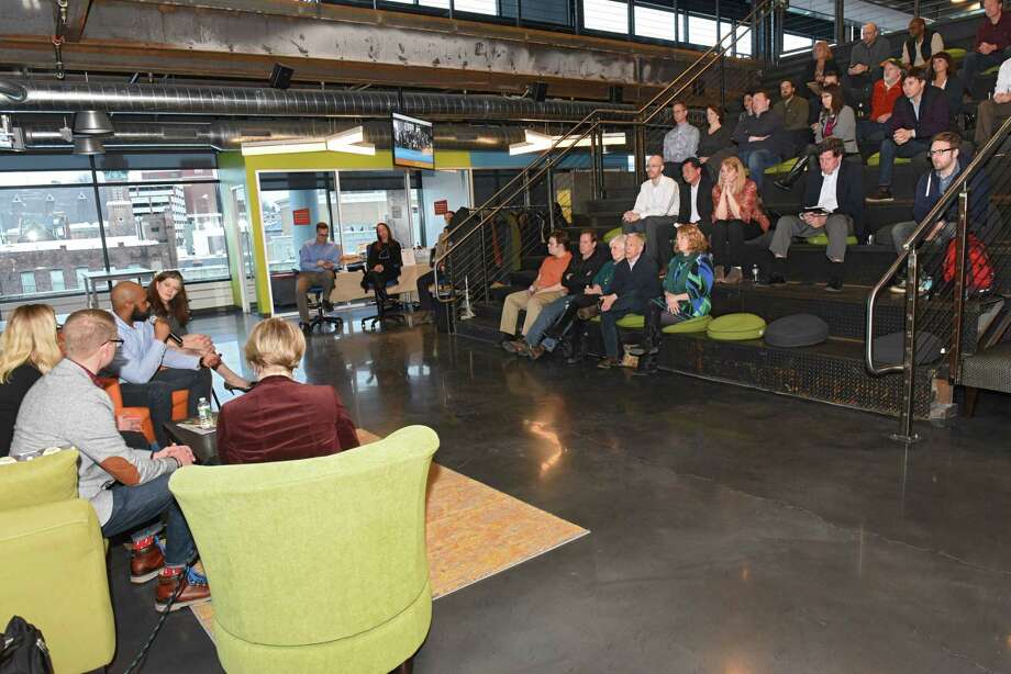 People listen to the 4th Family team speak about their project as Albany Can Code holds a unique ceremony to recognize the newest graduates at URBAN CO-WORKS on Wednesday, March 14, 2018 in Schenectady, N.Y. (Lori Van Buren/Times Union) Photo: Lori Van Buren, Albany Times Union / 20043207A
