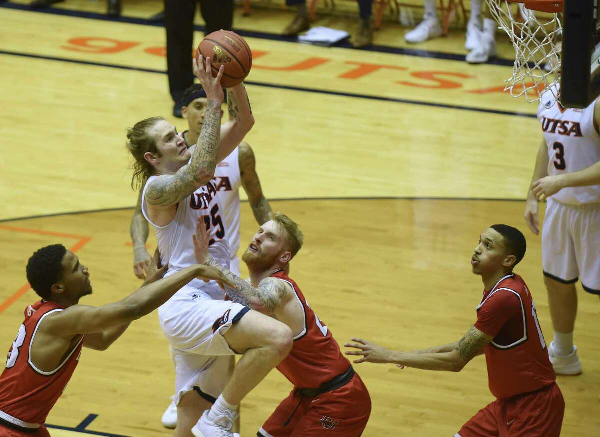 UTSA's Nick Allen is fouled by Lamar's Jordan Foster, left, and Colton Weisbrod during second-half CollegeInsider.com tournament action in the UTSA Convocation Center on Wednesday, March 14, 2018. UTSA won the game, 76-69.