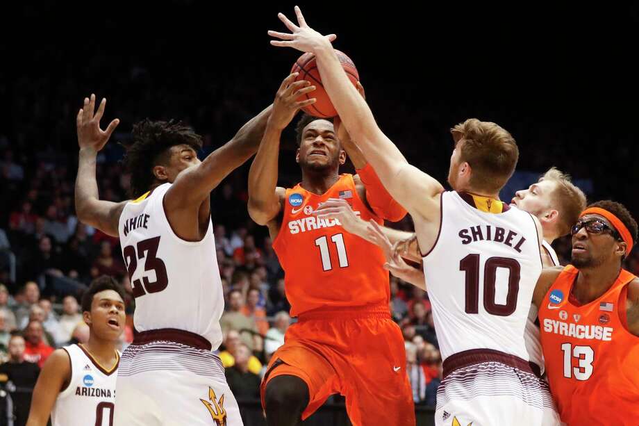 Syracuse's Oshae Brissett (11) drives against Arizona State's Romello White (23) and Vitaliy Shibel (10) during the second half of a First Four game of the NCAA men's college basketball tournament Wednesday, March 14, 2018, in Dayton, Ohio. Syracuse won 60-56. (AP Photo/John Minchillo) Photo: John Minchillo / AP