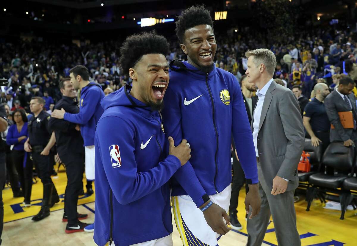 Golden State Warriors' Quinn Cook and Jordan Bell laugh after Warriors' 117-106 win over Los Angeles Lakers in NBA game at Oracle Arena in Oakland, Calif., on Wednesday, March 14, 2018.