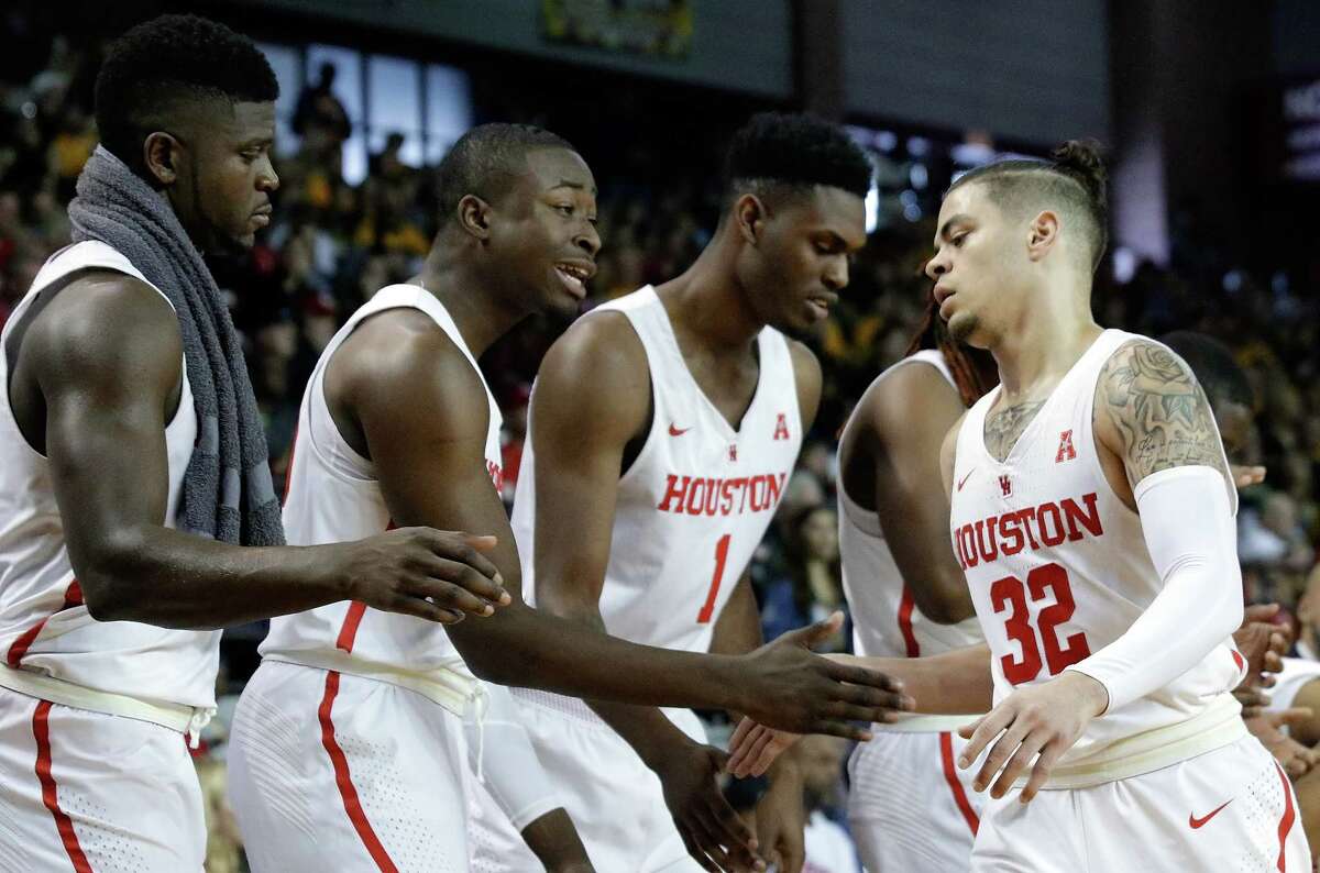 Houston guard Rob Gray (32) gets congrats from forward Nura Zanna (13), forward Gabe Grant (20) and center Chris Harris Jr. (1) on the bench as he comes in for a break during the second half of their game against Wichita State at H&PE Arena at Texas State University Saturday, Jan. 20, 2018, in Houston, TX. (Michael Wyke / For the Chronicle)