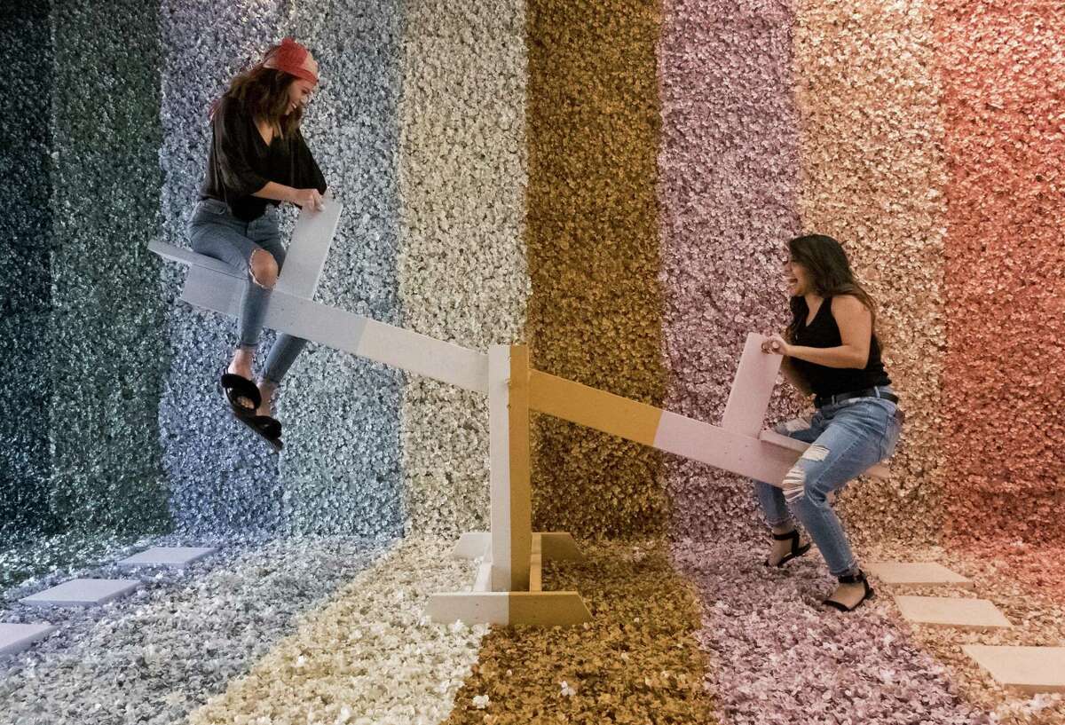The Flower Vaults has returned. Friends Abby Marin (right) and Sarah Garcia play on the see-saw in the Flower Vault’s Rainbow Room. 