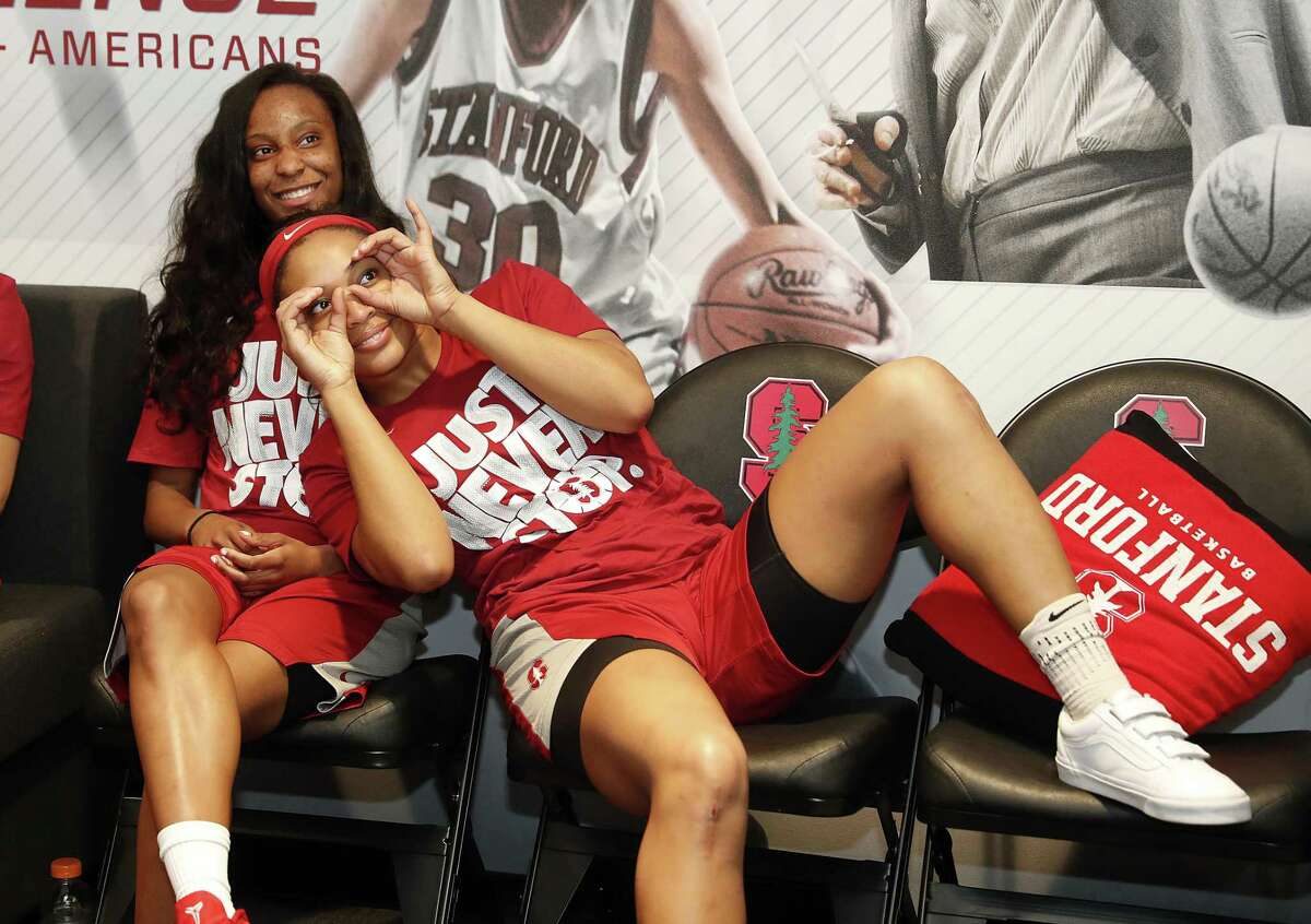 Stanford guard Kiana Williams, left, and guard DiJonai Carrington, right, joke around as they watch the television broadcast of their selection in the NCAA women's college basketball tournament Monday, Mar. 12, 2018 in Stanford, Calif. Stanford will host the first two rounds in the NCAA Tournament and will open as a No. 4 seed against 13-seed Gonzaga.