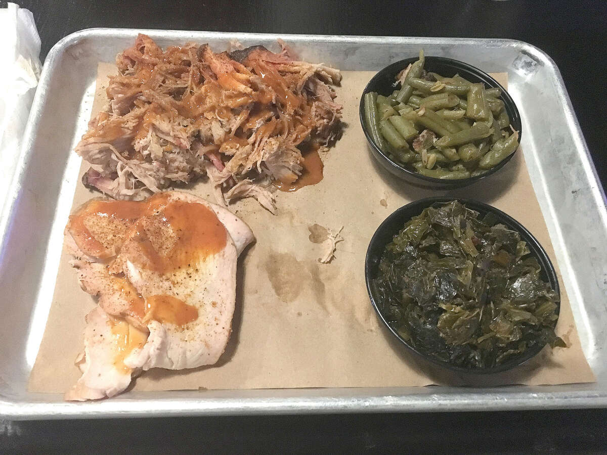 A platter from 17th Street Barbecue at 2700 17th St. in Marion, featuring pork shoulder, smoked turkey, brisket green beans and collard greens.