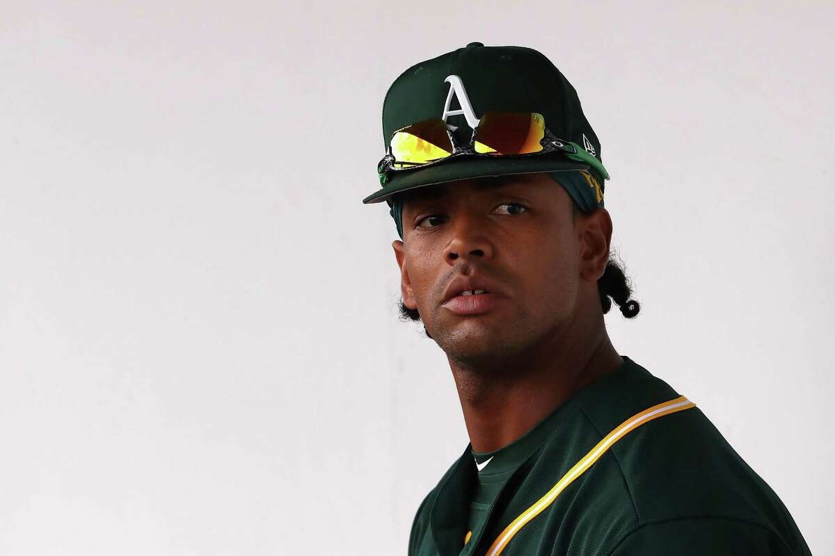 Khris Davis #2 of the Oakland Athletics sits in the dugout before the spring training game against the Chicago Cubs at Sloan Park on February 28, 2018 in Mesa, Arizona. 