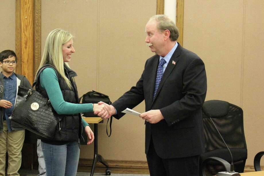 State Sen. Michael McLachlan presents the Danbury Education Foundation’s Classroom Excellence Grant of almost $1,500 to first-grade teacher Jessica Archambault to fund her programs for interactive whiteboards at Morris Street School. Photo: / Submitted Photo