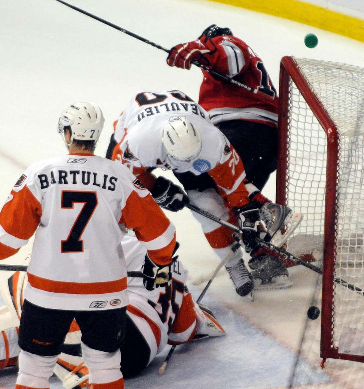 Jacob Micflicker of the River Rats, right, crashes into the goal post after scoring a goal against against the Phantoms. (Hans Pennink/Special to the Times Union)