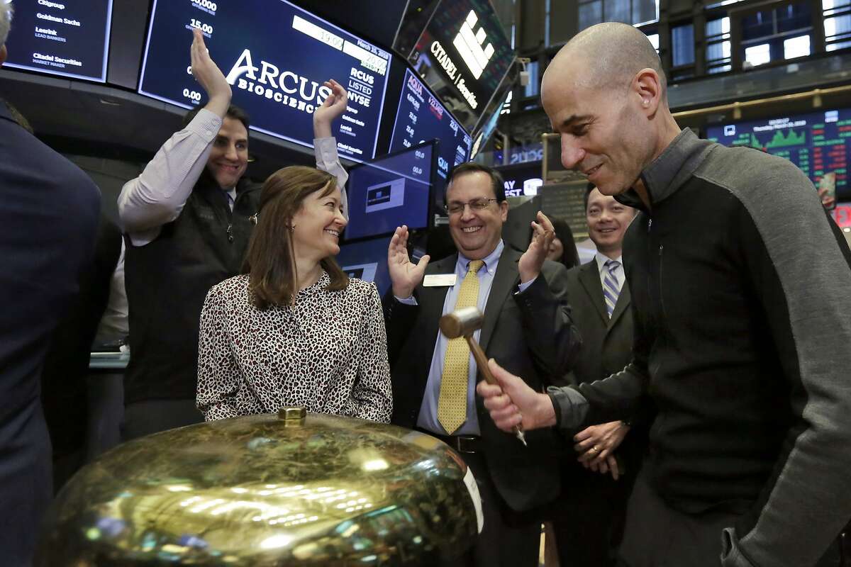 Arcus Biosciences Founder and CEO Terry Rosen, right, is applauded as he rings a ceremonial bell when his company's IPO begins trading on the floor of the New York Stock Exchange, Thursday, March 15, 2018. (AP Photo/Richard Drew)