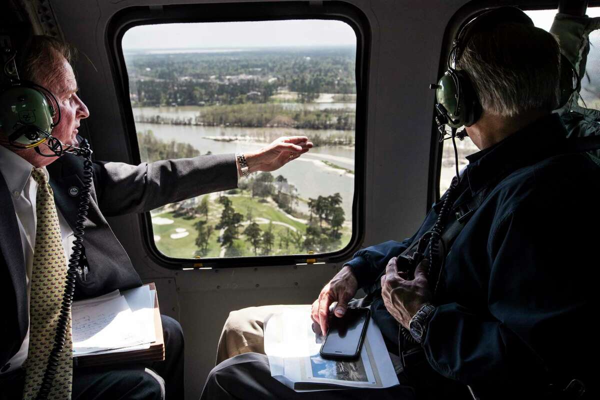 Dave Martin, Houston city councilman, District E, left, speaks to Gov. Greg Abbott as they take an aerial tour over the San Jacinto River, downstream from Lake Conroe, on Thursday, March 15, 2018, in Houston. The Kingwood area suffered serious flooding during Hurricane Harvey due in part to sand washed downstream from sand mining operations along the river.