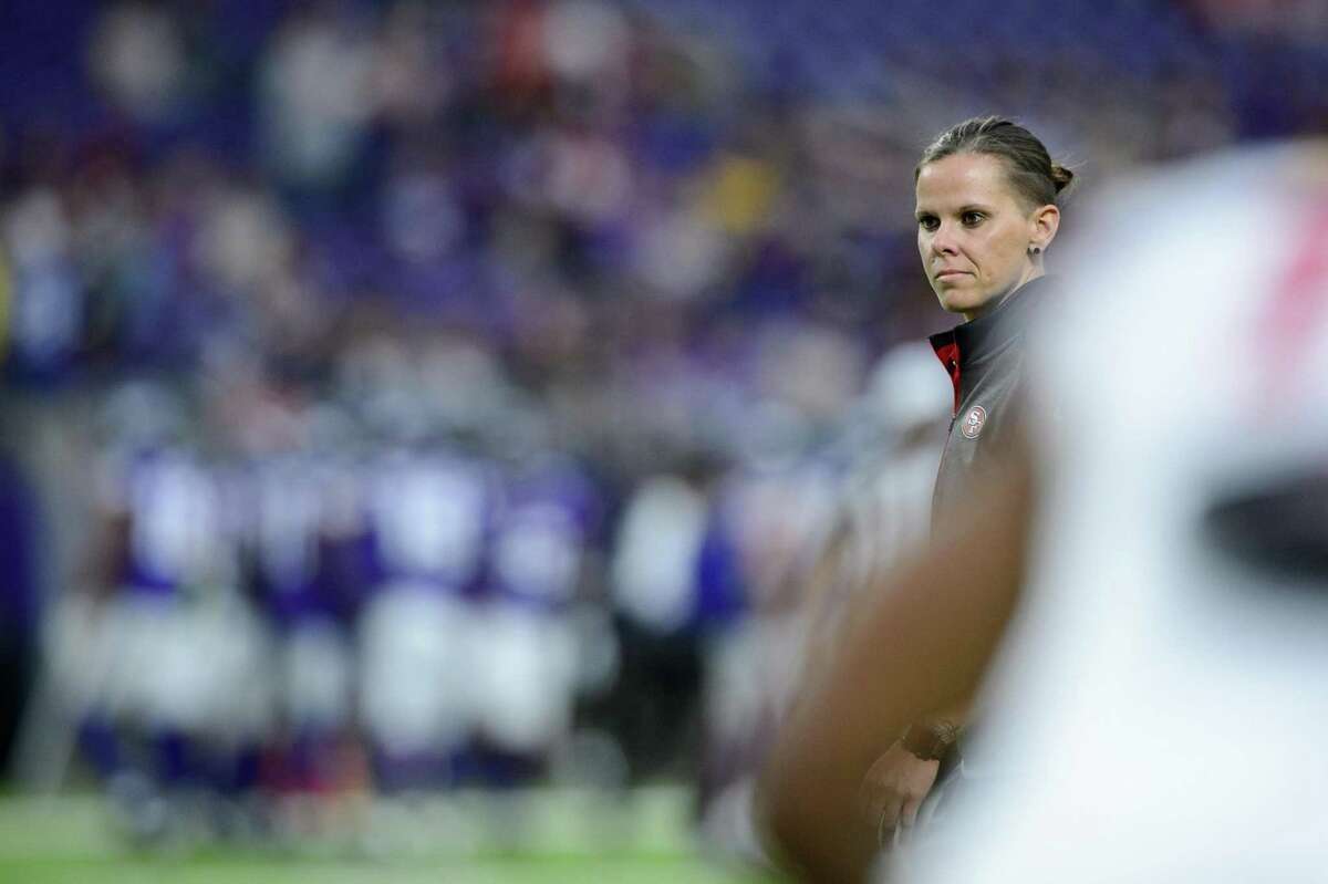 Assistant coach Katie Sowers of the San Francisco 49ers looks on during warmups before the preseason game on August 27, 2017 at U.S. Bank Stadium in Minneapolis, Minnesota. The Vikings defeated the 49ers 32-31.