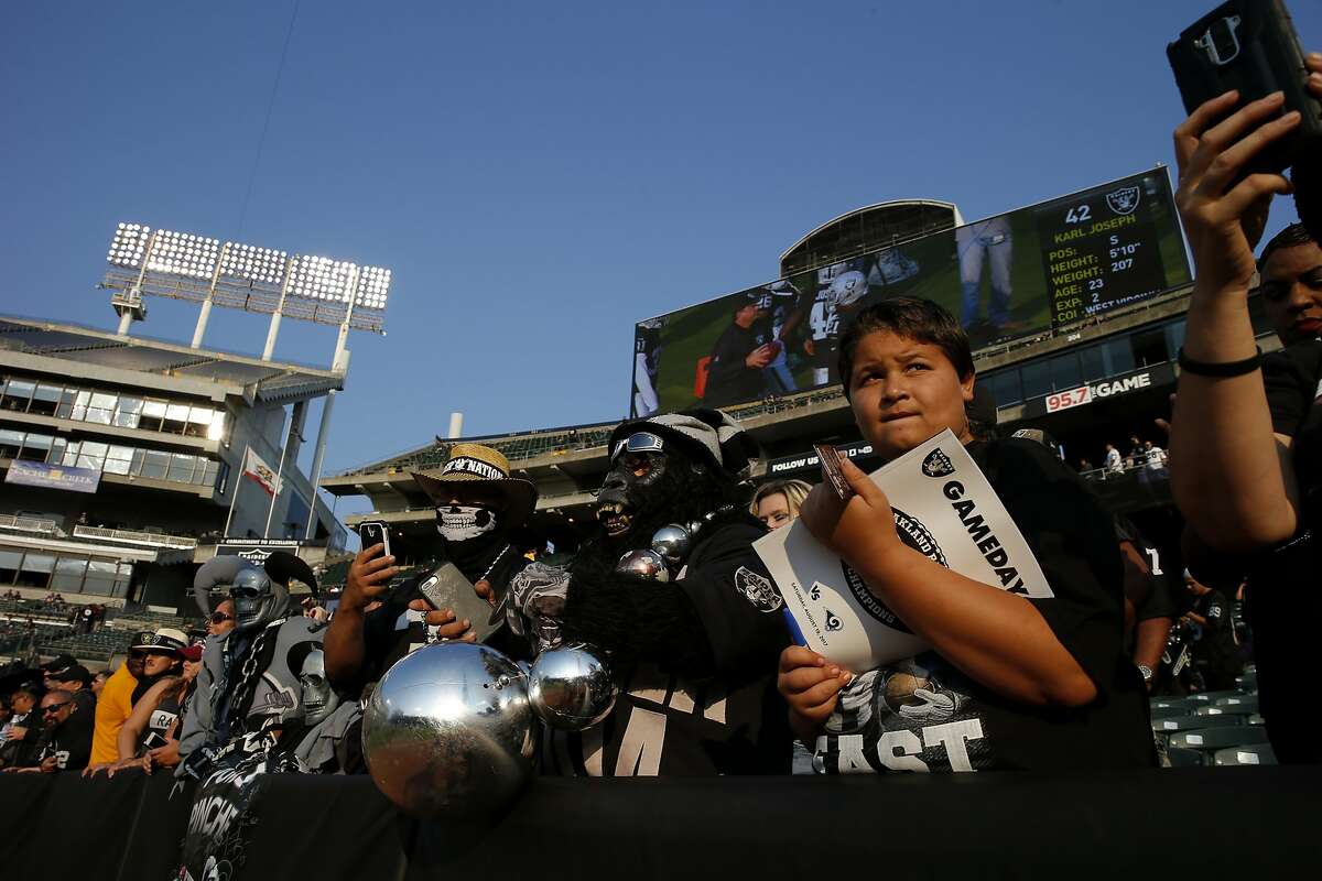 Oakland Raiders fans spectate the warm ups before an NFL preseason football game between the Oakland Raiders and the Los Angeles Rams on Saturday, Aug. 19, 2017, at the Oakland Coliseum in Oakland, Calif.