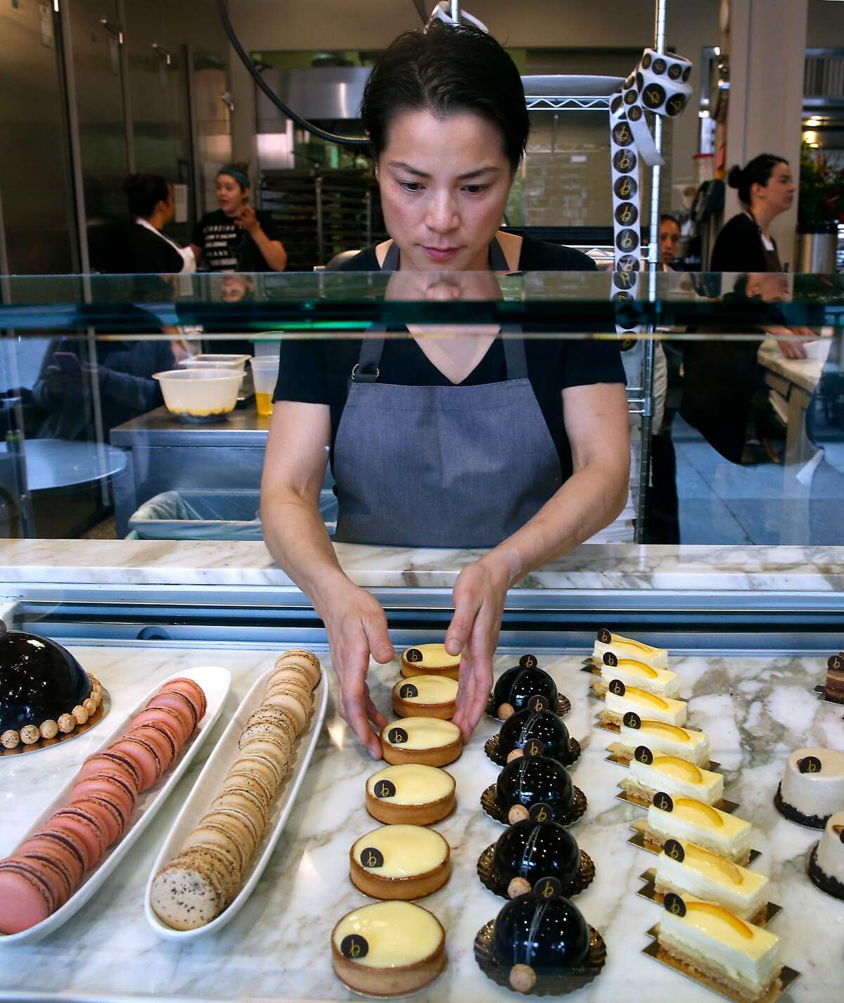 Co-owner Belinda Leong arranges pastries in a display case at b. Patisserie on California Street in San Francisco, Calif. on Saturday, March 10, 2018. Owners of the popular bakery are opening a shop in Seoul, South Korea next month.