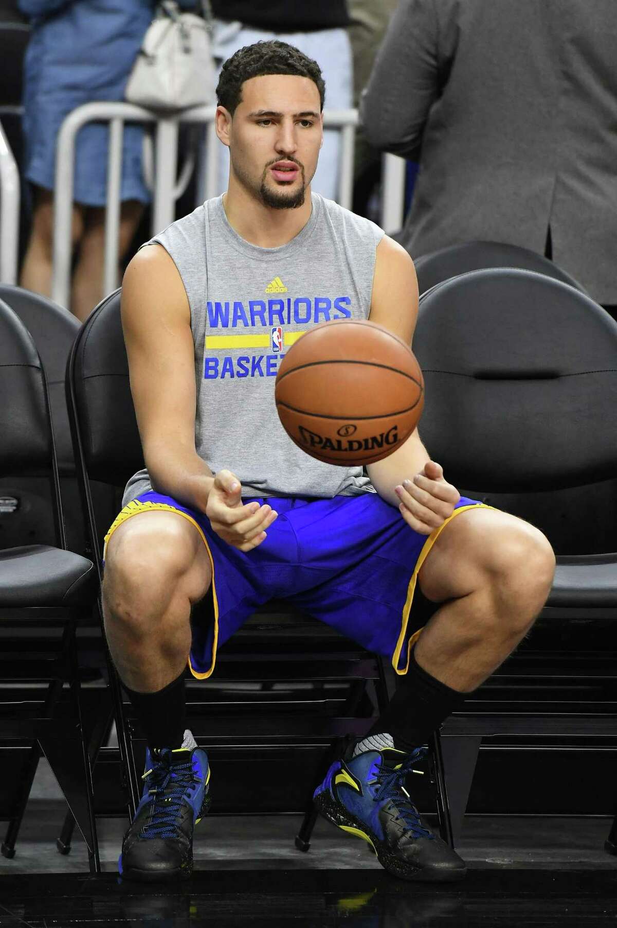 Klay Thompson #11 of the Golden State Warriors sits on the bench during warmups before a preseason game against the Los Angeles Lakers at T-Mobile Arena on October 15, 2016 in Las Vegas, Nevada.