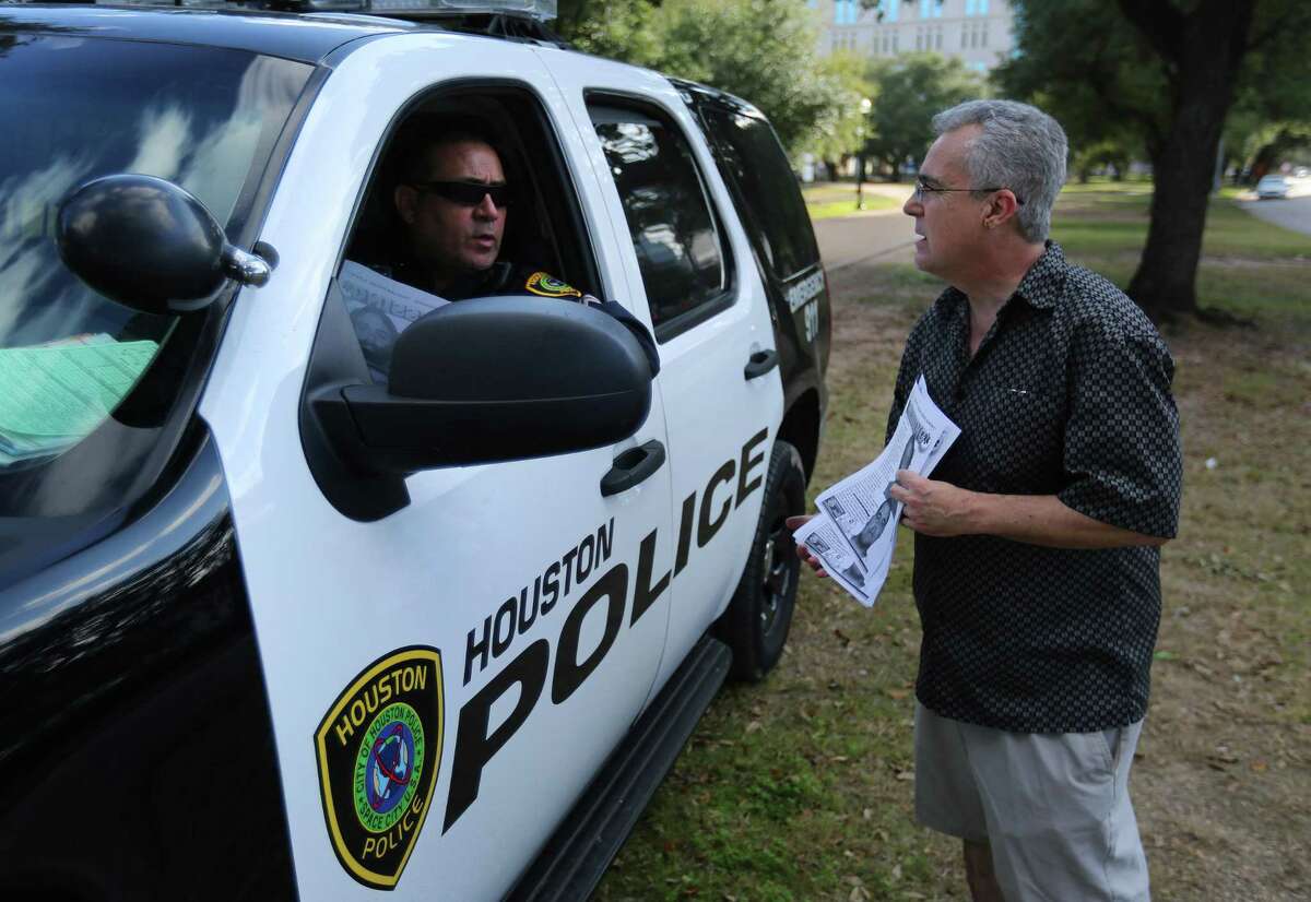 George Ruano talks to a Houston police officer in Hermann Park while handing out fliers including pictures and information about his missing brother, Thursday, Jan. 12, 2017, in Houston. Ruano has been searching for his brother, Daniel Almendi, who suffers from schizophrenia, since Daniel was released from the Harris County Psychiatric Center on Nov. 30, 2016. ( Mark Mulligan / Houston Chronicle )
