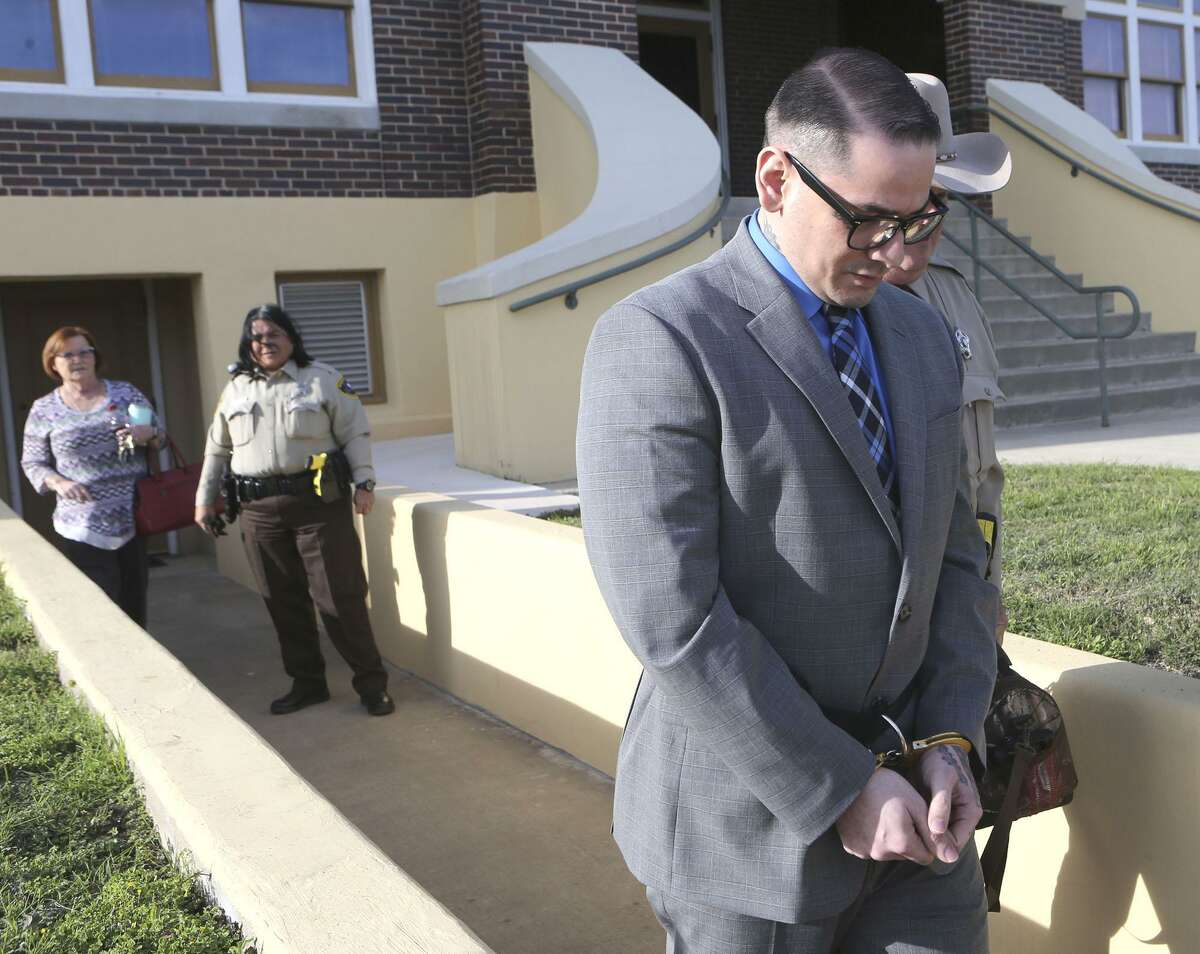 Murder defeandant Shaun Puente (right, foreground) leaves court in Jourdanton, Texas Thursday March 8, 2018. Shaun Puente is accused in the 2013 murder of San Antonio police officer Robert Deckard. Puente is accused of shooting Deckard,31, in the forehead as he led a chase from San Antonio into Atascosa County.