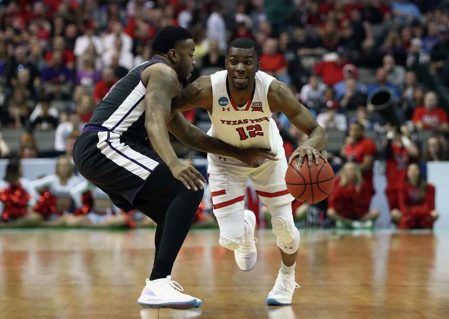 DALLAS, TX - MARCH 15: Keenan Evans #12 of the Texas Tech Red Raiders drives against Ty Charles #4 of the Stephen F. Austin Lumberjacks in the first half in the first round of the 2018 NCAA Men's Basketball Tournament at American Airlines Center on March 15, 2018 in Dallas, Texas.  (Photo by Ronald Martinez/Getty Images) Photo: Ronald Martinez / 2018 Getty Images