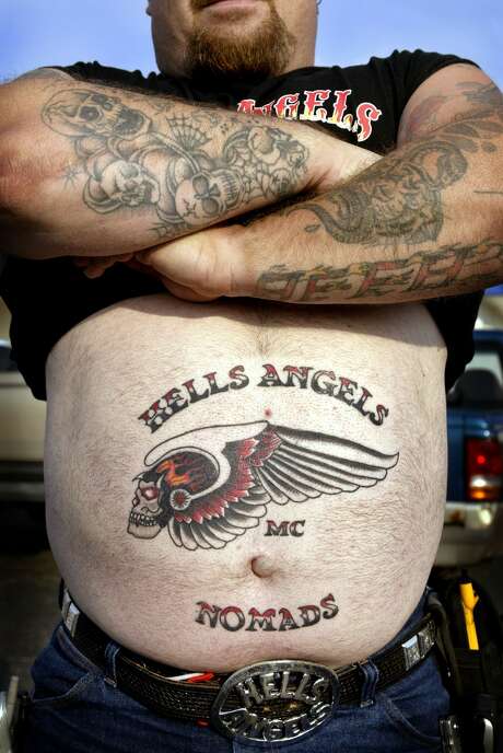 Nomad Dave shows off the new Hells Angels tattoo on his stomach as he attends a Hells Angels rally July 26, 2003 in Peru, Illinois. Dave is a member of the Illinois Nomads charter of the Hells Angels. Photo: Scott Olson/Getty Images