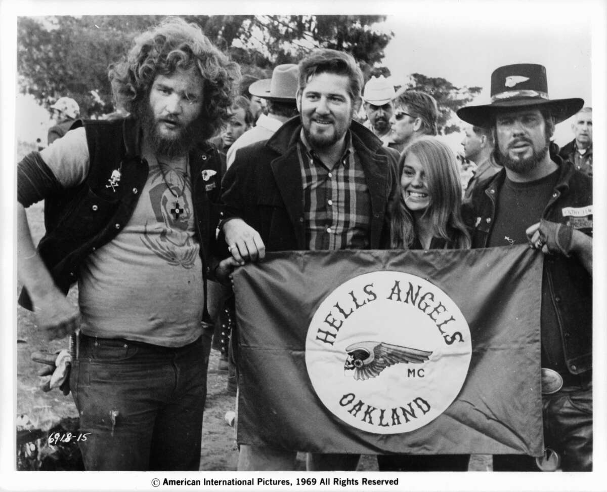 Sonny Barger and the Hell's Angels holding their flag in a scene from the film 'Hell's Angels '69', 1969.